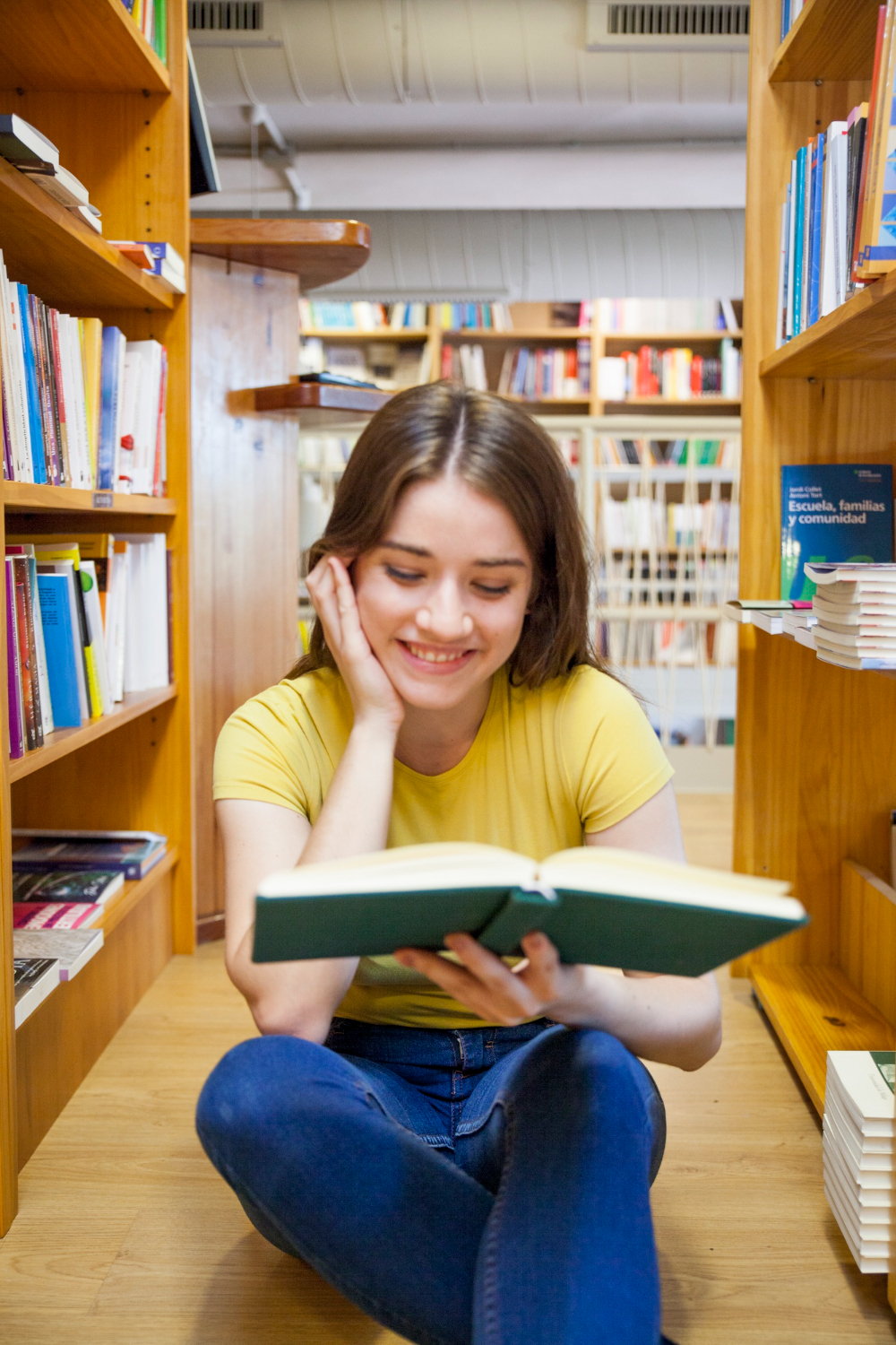 smiling teen girl enjoying reading floor